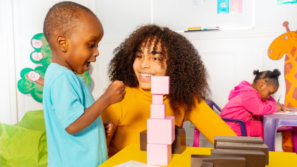 Kid Building Blocks with Teacher