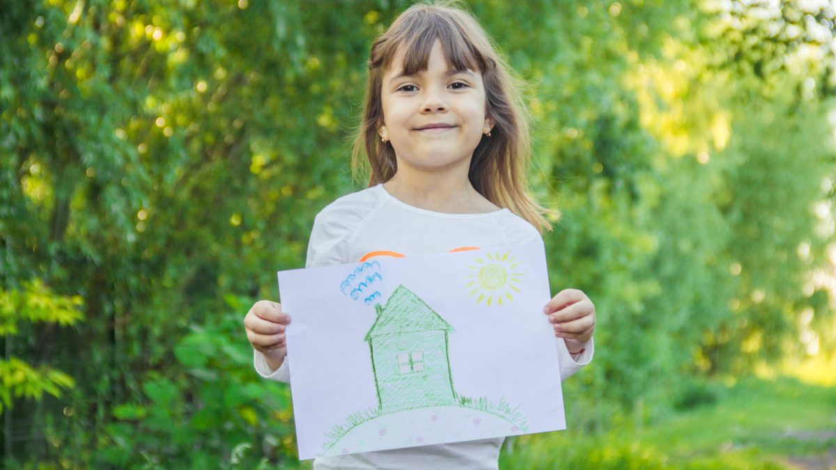 Girl Holding House Drawing