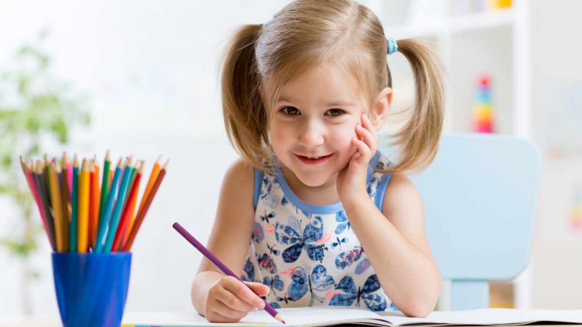 Girl Drawing on Book