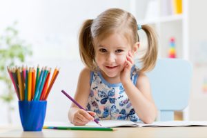 Girl Drawing on Book